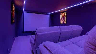 a purple room with a couch and a screen at Portuguese mansion close to marina, golf and beach. in Vilamoura