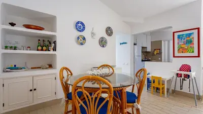 a kitchen and dining room with a table and chairs at Sea 3BDR House W/ Patio by Lovelystay in Albufeira