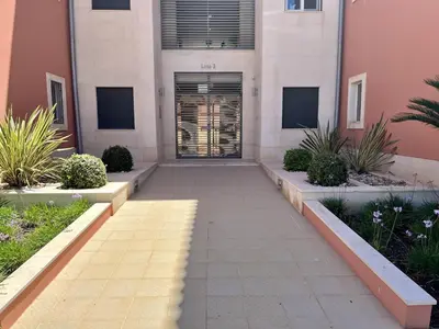 a walkway in front of a building with a door at Vilamoura Victoria Gardens With Pool by Homing in Vilamoura