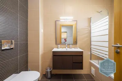 a bathroom with a sink and a toilet and a mirror at Jardins da Marina - Dream Lodging in Albufeira
