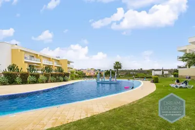 a pool at a resort with a fountain at Jardins da Marina - Dream Lodging in Albufeira