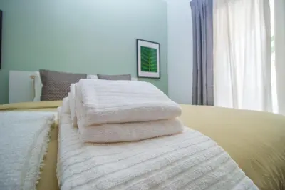 a pile of towels sitting on top of a bed at Apartment close to golf, beaches, Quinta Lago, Vale Lobo, Quarteira and Vilamoura in Quinta do Lago