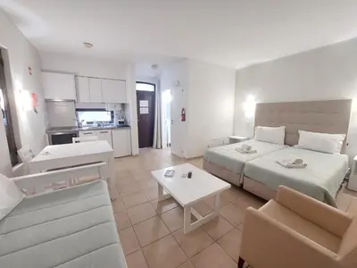 a bedroom with a bed and a living room at A CASA da PRAIA ALBUFEIRA PORTUGAL in Albufeira