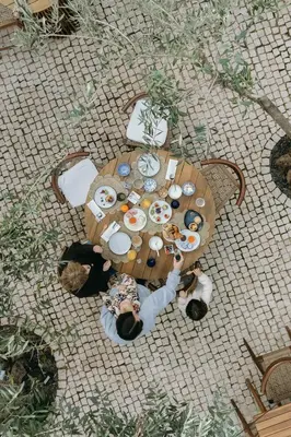 a group of people sitting around a wooden table at Eleven, Boutique luxury house & garden in Boliqueime