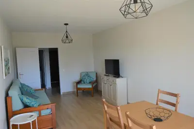 a living room with a couch and a table at Apartamento Azul in Quarteira