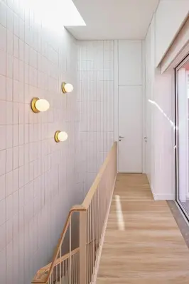 a hallway with white tiled walls and a staircase at Bougainvillea 33 by My Cozy Home in Faro
