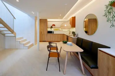 a kitchen and dining room with a table and chairs at Bougainvillea 33 by My Cozy Home in Faro