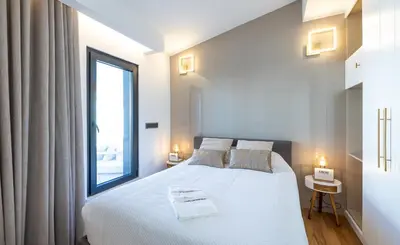 a bedroom with a white bed and a large window at Medusa Luxury Marina in Vilamoura
