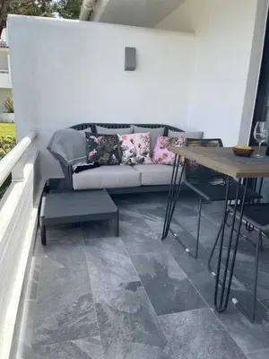 a living room with a couch and a table at Scarlet's Place - 1 bed Victory Village Quinta Do Lago - beach, nature, lakes in Quinta do Lago