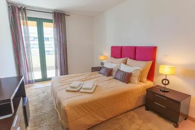 a bedroom with a large bed with two towels on it at Marina Vilamoura - Aquamar 214 - By Vilamoura Sun in Vilamoura