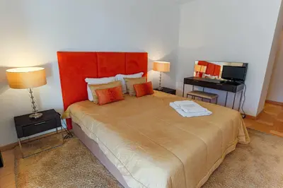 a bedroom with a large bed with a red headboard at Marina Vilamoura - Aquamar 214 - By Vilamoura Sun in Vilamoura
