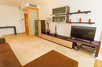 a living room with a large flat screen tv at Marina Vilamoura - Aquamar 214 - By Vilamoura Sun in Vilamoura