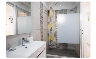 a bathroom with a sink and a shower at BeGuest Casetta Cleo in Páteo