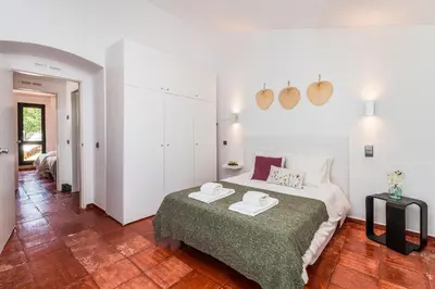 a bedroom with a bed with two towels on it at Casas Barulho - Villa Jacaranda A8 in Albufeira