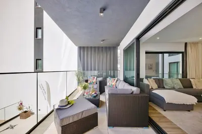 a living room with a couch and a table at Bright Modern Beachside Apartment with Pool & Seaview in Quarteira