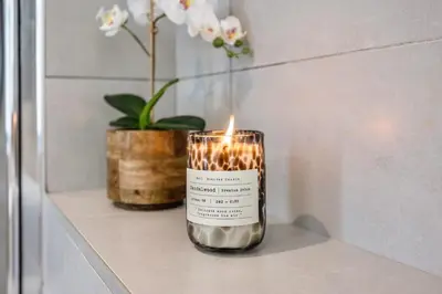 a candle sitting on a shelf with a plant at 2-Bedroom Beachside Apartment with Pool & Parking in Quarteira