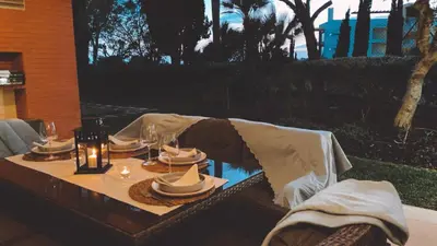 a table with a table cloth and plates of food at THE PALM at the Palm Village 2 Bedrooms Apartment in Vilamoura