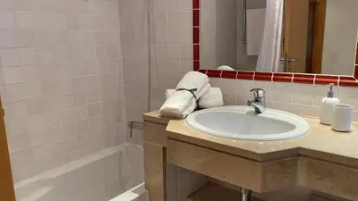 a bathroom with a sink and a bath tub at THE PALM at the Palm Village 2 Bedrooms Apartment in Vilamoura