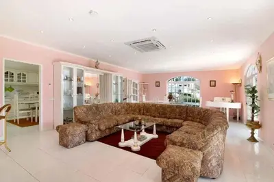 a living room with a large couch and a table at Algarve Paraíso Casa Lagos e Relvas in Estói