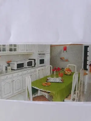 a kitchen with a table with a green table cloth at Algarve Paraíso Casa Lagos e Relvas in Estói
