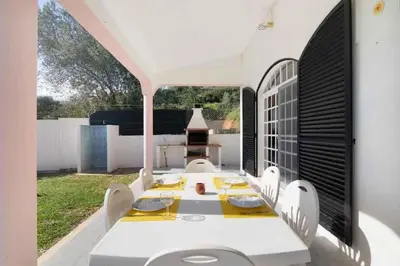 a white dining room with a table and chairs at Algarve Paraíso Casa Lagos e Relvas in Estói