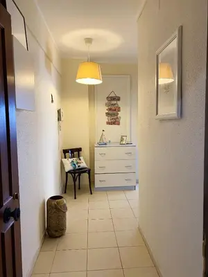 a kitchen with a table with chairs and a kitchen counter at Charming Vilamoura Apartment with Shared Pool in Vilamoura