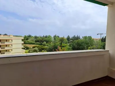 a table and chairs on a balcony with a view at Charming Vilamoura Apartment with Shared Pool in Vilamoura