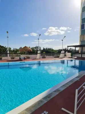 a large blue swimming pool in a hotel at Charming Vilamoura Apartment with Shared Pool in Vilamoura