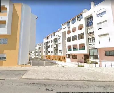 an empty street in front of buildings at A Santo, Quarteira - By Urbinvest Algarve in Quarteira