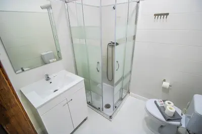 a bathroom with a shower and a toilet and a sink at Vilamoura Golf Studio With Pool by Homing in Vilamoura