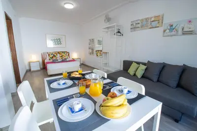 a living room with a table with bananas on it at Vilamoura Golf Studio With Pool by Homing in Vilamoura