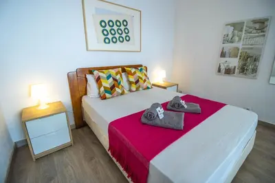 a bedroom with a bed with two towels on it at Vilamoura Golf Studio With Pool by Homing in Vilamoura