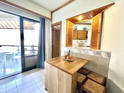 a kitchen with a counter with a table in it at Talia XII - Near the beach by HD PROPERTIES in Vilamoura