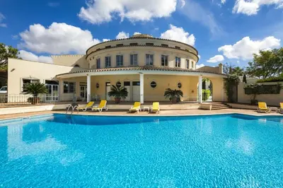 a house with a swimming pool in front of a house at Sera - Luxury 3 bedroom apartment with pool, golf,beach in Ludo