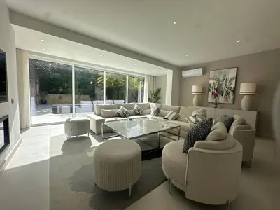 a living room with a couch and a glass table at Sunshine - PINHEIROS ALTOS in Quinta do Lago