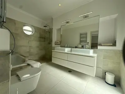 a bathroom with a sink and a toilet and a mirror at Sunshine - PINHEIROS ALTOS in Quinta do Lago