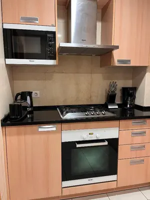 a kitchen with a stove and a microwave at Barracuda ByTheSea in Albufeira
