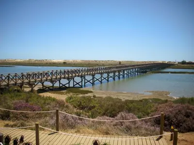 a bridge over a river next to a body of water at Victory Village 10C in Quinta do Lago