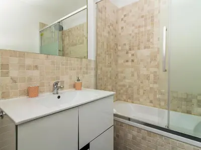 a bathroom with a sink and a bath tub at Villa Double Joy by Stay ici Algarve Holiday Rental in Albufeira