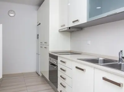 a white kitchen with a sink and a stove at Villa Double Joy by Stay ici Algarve Holiday Rental in Albufeira
