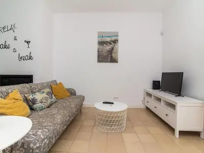 a living room with a couch and a tv at Rainbow House by Stay ici Algarve Holiday Rental in Albufeira