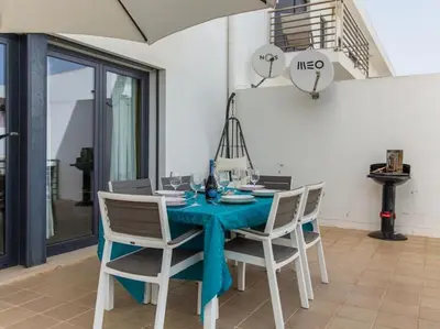 a dining room with a blue table and chairs at Rainbow House by Stay ici Algarve Holiday Rental in Albufeira