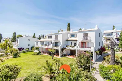 an aerial view of a large white house with a yard at #088 T2 São Rafael 64B by Home Holidays in Albufeira