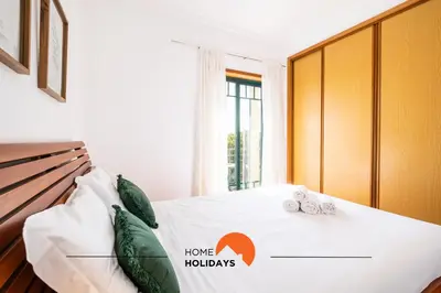 a bedroom with a bed with two towels on it at #020 Medronheira by Home Holidays in Albufeira