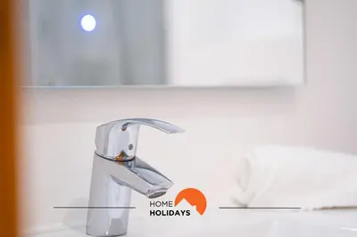 a bathroom with a white toilet and a mirror at #020 Medronheira by Home Holidays in Albufeira