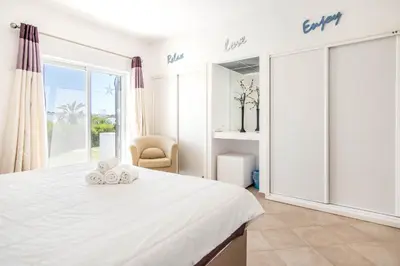 a kitchen and dining room with a table and chairs at #025 T3 Encantador em Albufeira by Home Holidays in Albufeira