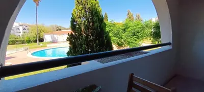 a window with a view of a swimming pool at 211 Apartamento moderno com vista para a piscina no centro da cidade in Albufeira