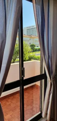 an open glass door with a view of a balcony at Villa charmosa V2 junto à praia e à Marina de Vilamoura in Quarteira