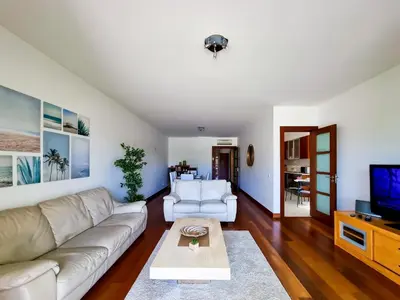 a living room with a couch and a tv at FLH Vilamoura Villa Rosa Golf Apartment with Pool in Vilamoura