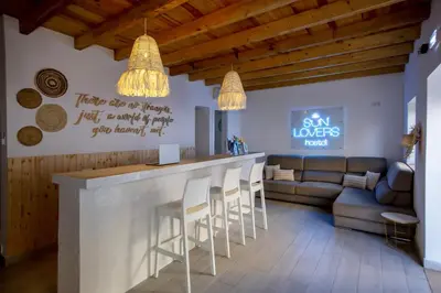 a living room with a bar and a couch at Sun Lovers Hostel in Albufeira